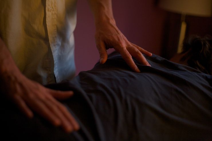 hands touching spine